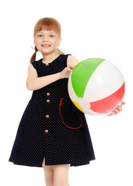 Little girl is playing with a ball - Foto, immagini