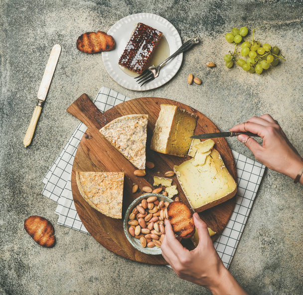 Cheese platter with female hands  - Foto, imagen