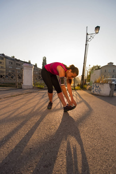 athlete woman warming up and stretching - 写真・画像