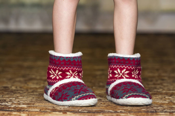 Bare child legs and feet in red winter christmas boots with orna - Φωτογραφία, εικόνα