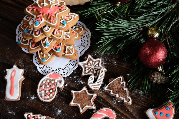 ginger biscuit and christmas decoration on dark wood background. soft light. - Foto, Imagem