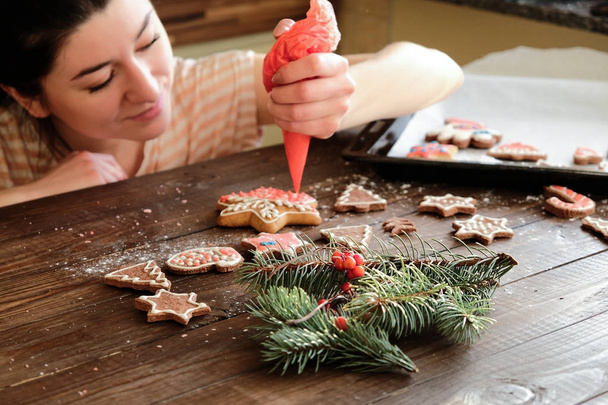 ginger biscuit and christmas decoration on dark wood background. soft light. - Foto, afbeelding