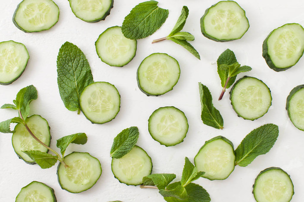 Background of sliced cucumbers with sprigs of greenery - Photo, Image