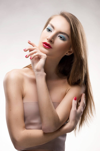 The beautiful blonde red lips smiling girl touches by fingers fa - Foto, afbeelding