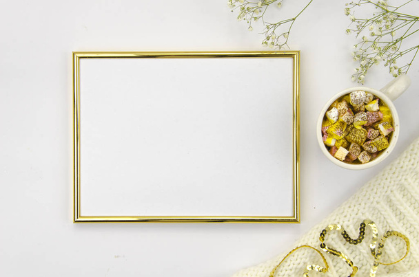 Golden frame with cup and marshmallow white and golden colors. Flat lay mock up - Photo, Image
