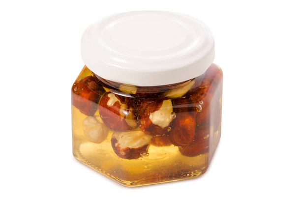 A honey jar with nuts - Fotoğraf, Görsel