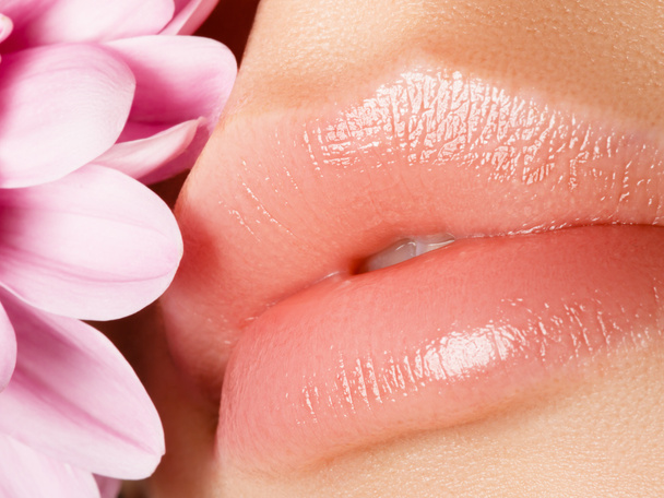 Lips augmentation. Perfect natural lip makeup. Close up macro photo with beautiful female mouth. Plump full lips. Close-up face detail. Perfect clean skin, light fresh lip make-up - 写真・画像