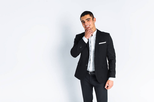 handsome young man in a stylish suit, posing on a white background isolated - Photo, image