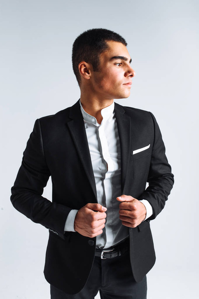 handsome young man in a stylish suit, posing on a white background isolated - Foto, Imagem