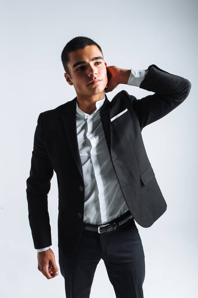 handsome young man in a stylish suit, posing on a white background isolated - Photo, Image