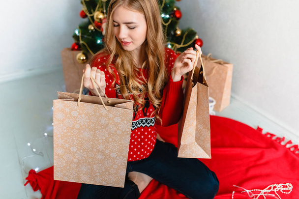 The girl with the gifts. Portrait of a girl. Girl smiling. Girl celebrates Christmas - Фото, изображение