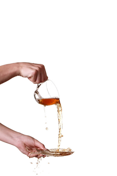 Brown splashes out drink from glass isolated - 写真・画像