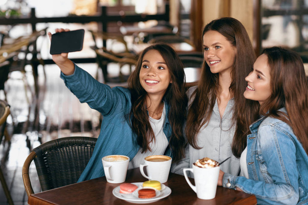 Beautiful Girls In Cafe Taking Selfie Photo On Phone. - Photo, Image