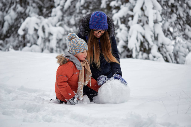 winter fun. a girl and a boy making snowballs. - Photo, Image