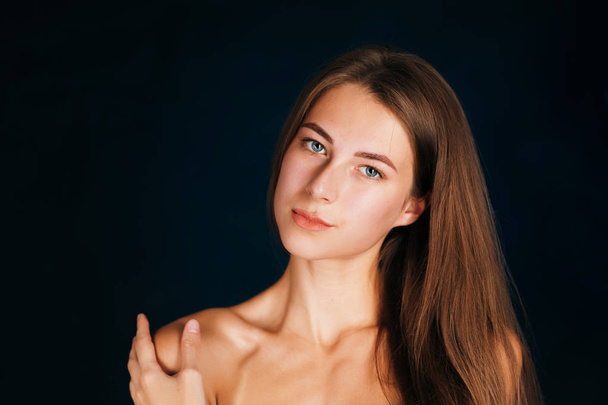 Portrait beautiful girl on a dark studio background - Фото, изображение