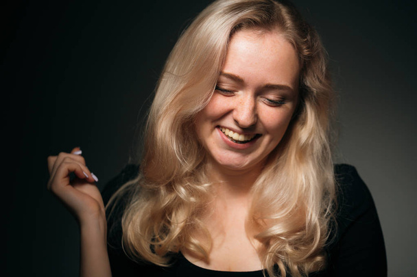 young girl blonde on a dark background - Foto, Imagem