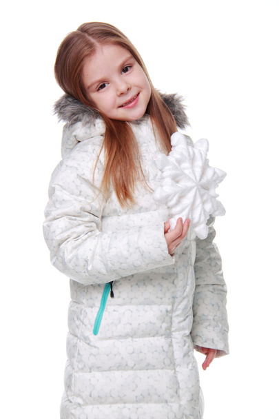 Christmas girl with snowflake in hands - Фото, изображение