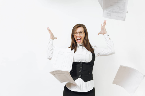 Shocked perplexed stress angry caucasian young business woman in black suit, white shirt, glasses throwing work documents isolated on white background. Manager or worker. Copy space for advertisement. - Fotoğraf, Görsel