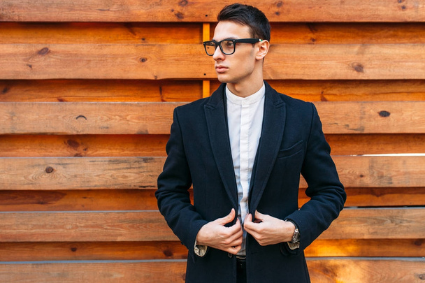 Stylish, man in classic costume, posing near wooden wall. Business style, life, work. - Foto, Imagem