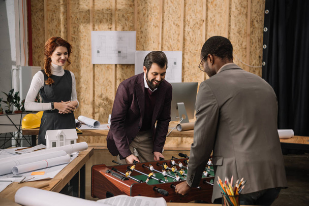 architects playing table football at modern office - Foto, Bild