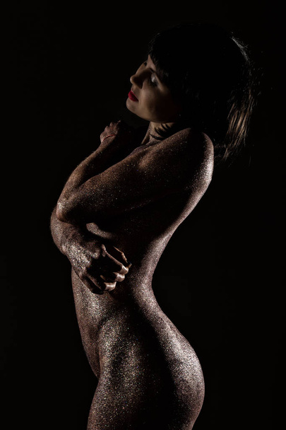 body art with purple sequins on a skin of beautiful nude girl on dark background - Foto, Imagem