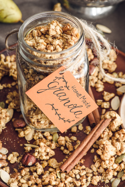 overhead view of homemade granola in glass jar with tag - Photo, Image
