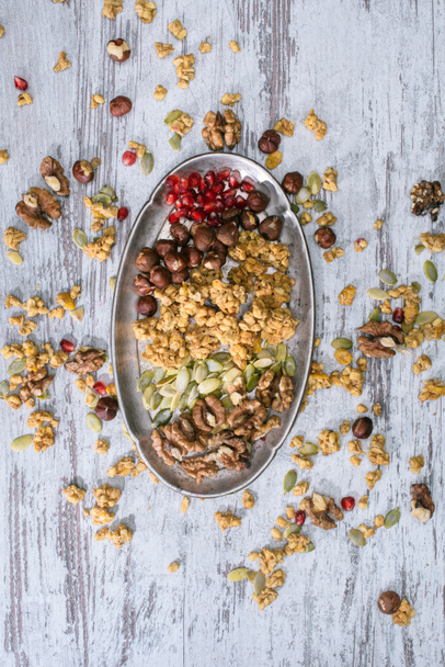 top view of granola ingredients on plate on wooden table - 写真・画像