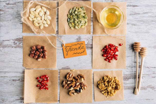 top view of granola ingredients with label on baking parchment pieces - Zdjęcie, obraz