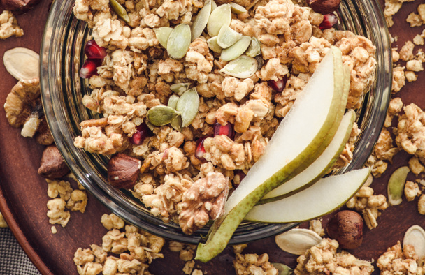 top view of homemade granola with pear and pumpkin seeds - Zdjęcie, obraz