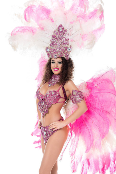 smiling woman posing in carnival costume with pink feathers, isolated on white - Foto, Imagem