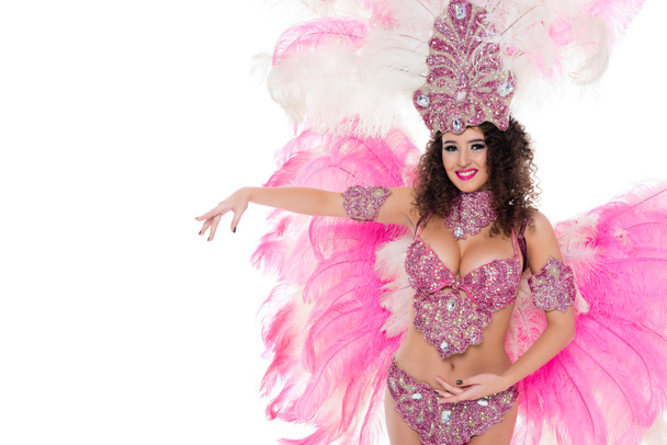 smiling girl posing in carnival costume with pink feathers, isolated on white - Fotó, kép