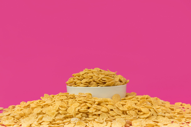 close-up view of white bowl with sweet crunchy corn flakes isolated on pink   - Photo, Image