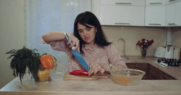 Woman in the kitchen prepare vegetables to make the food happy she cut them. 4k - Metraje, vídeo