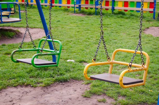Brightly colored swings on the Playground . - Photo, Image