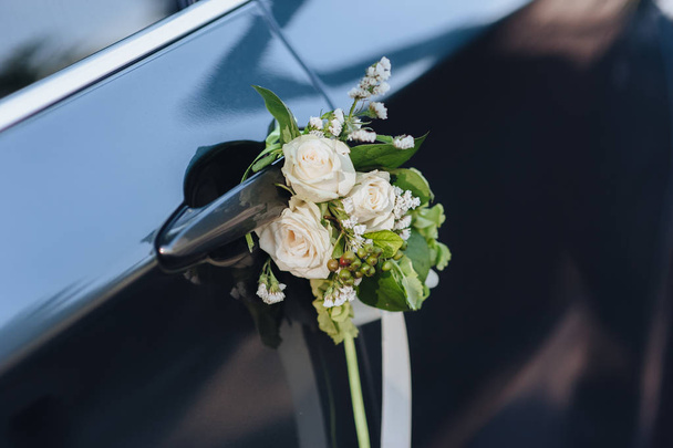 Luxury black wedding car decorated with flowers. - Fotó, kép