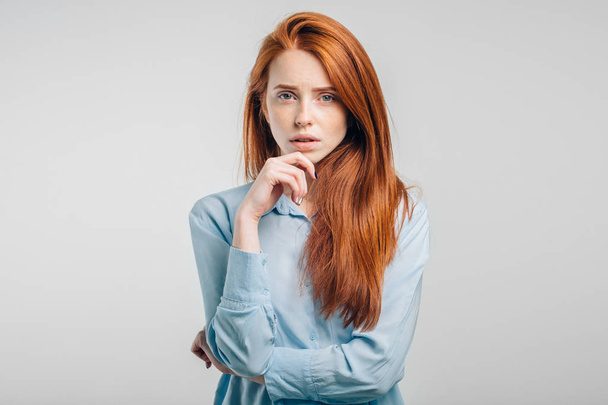 female with freckles and pursed lips having disappointed unhappy look - Фото, изображение