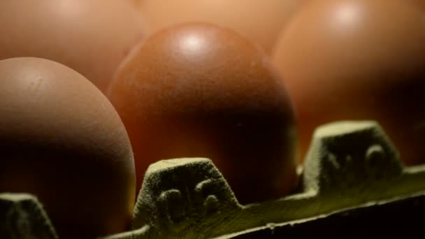 Brown eggs rotating in black background - Filmati, video