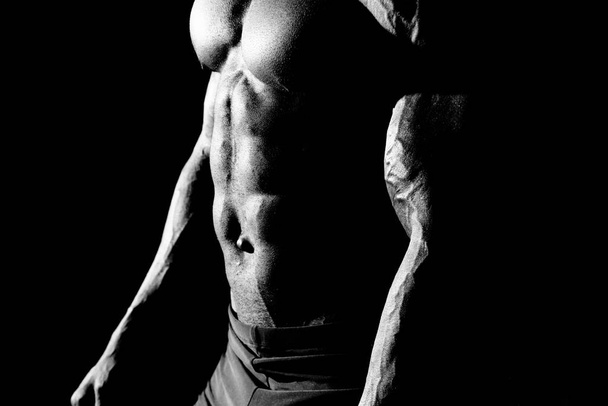 The abdominal muscles shows a young athlete - Photo, Image