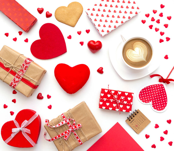 Cup of coffee and heart shaped cookies with gifts on white background. Happy valentine's day. Flat lay - Фото, зображення