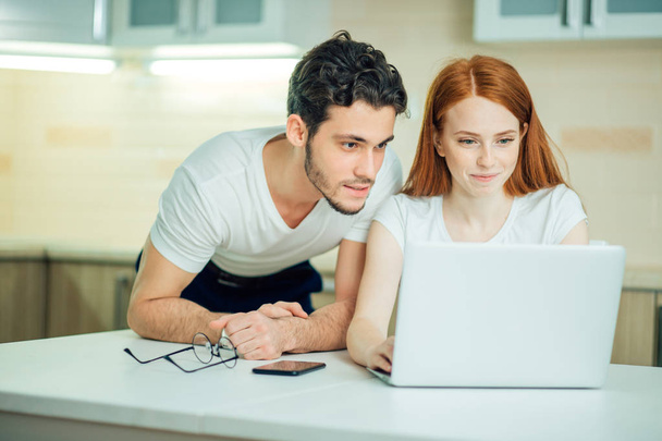 couple with laptop spending time together at home - Foto, immagini