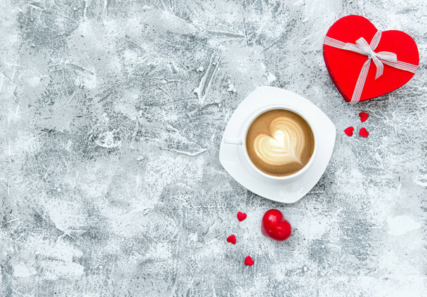 Cup of coffee with hearts on stone table. Top view with copy space. Valentine's day background - Photo, Image