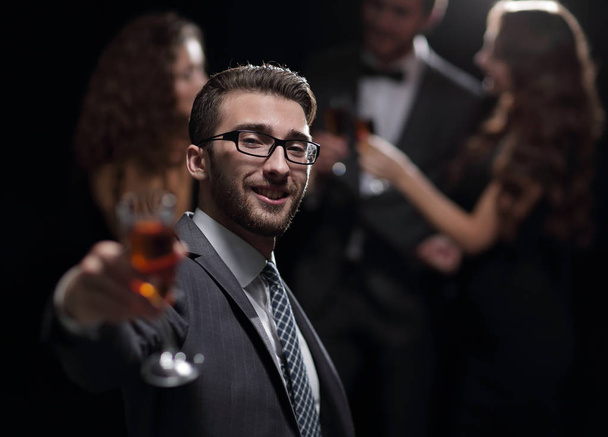 elegant man raising his glass with the toast - Fotografie, Obrázek