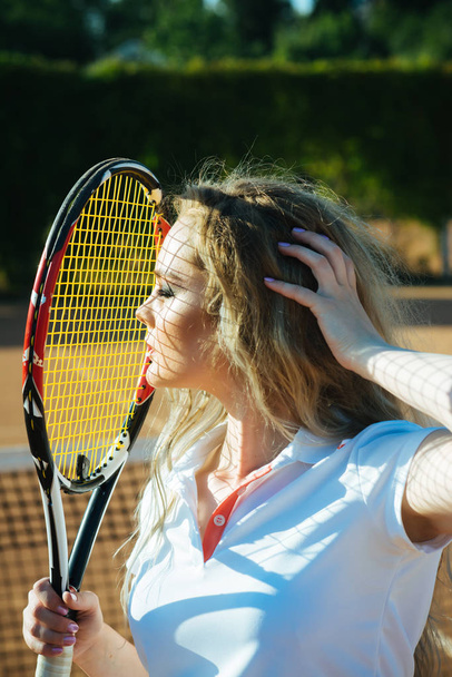 Woman player with tennis racket on sunny day - Zdjęcie, obraz