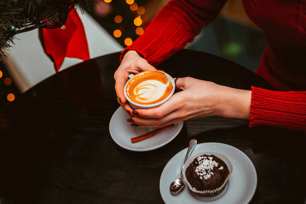 Cup of cappuccino in hands - Zdjęcie, obraz