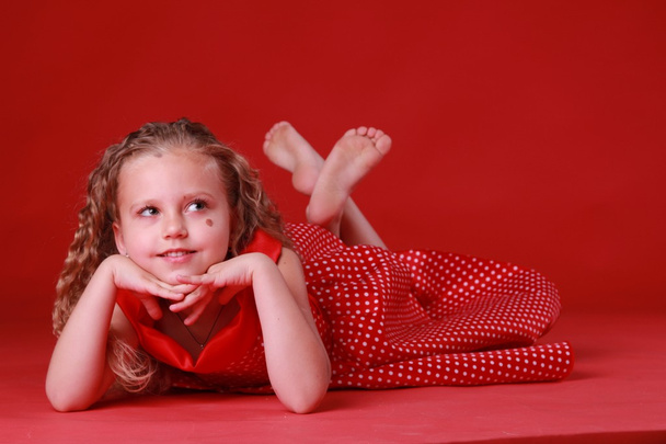 Little cute girl in a polka dot dress - Фото, изображение