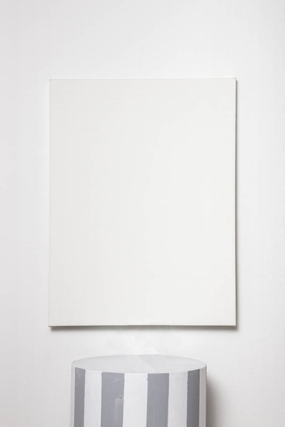 platform with canvas frame on white background. - Foto, afbeelding