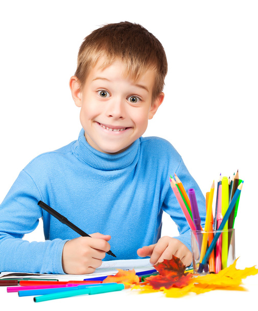 Funny boy is drawing with pencils - Foto, afbeelding