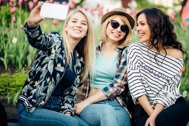 grupo de amigos sonrientes con smartphone fotografiando y tomando selfie
 - Foto, Imagen