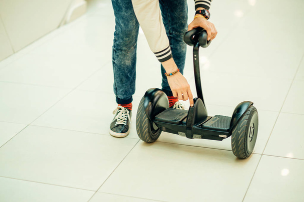 man activate electric segway at mall, active man using modern transport - Foto, afbeelding