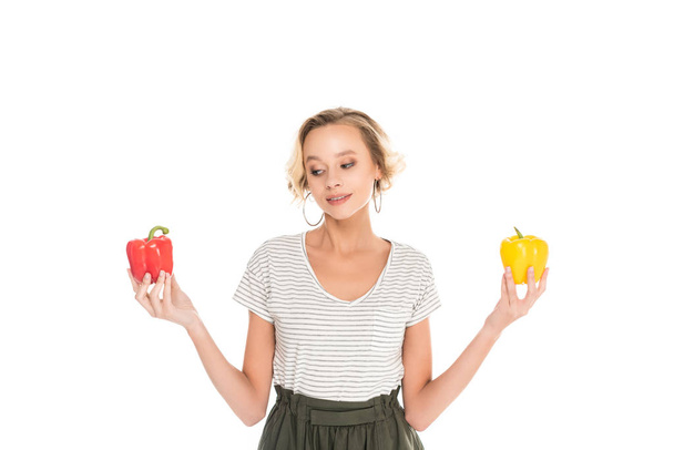 portrait of woman holding fresh bell peppers in hands isolated on white - Foto, afbeelding